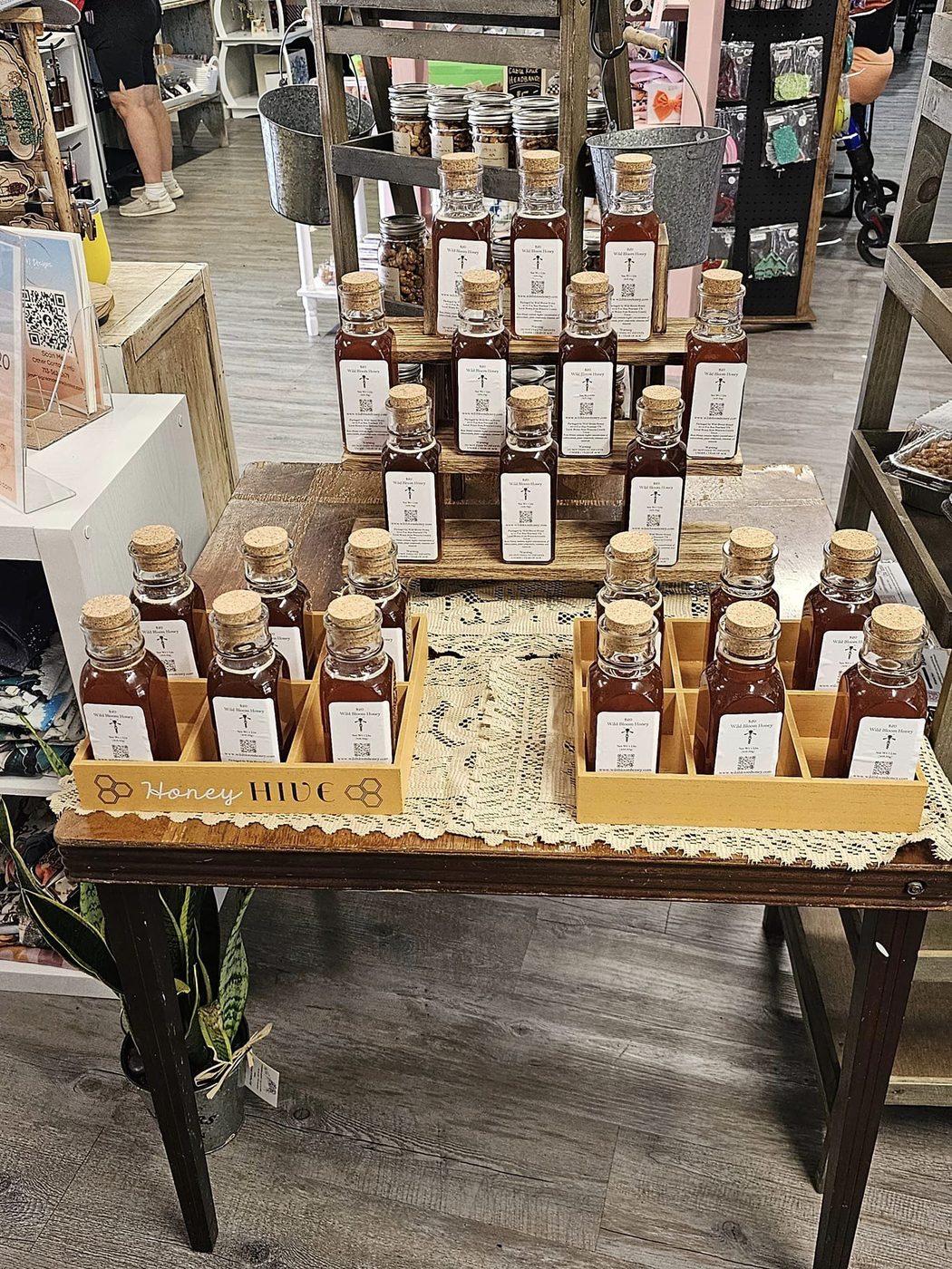 Bottles of Wild Bloom Honey arranged on a market display